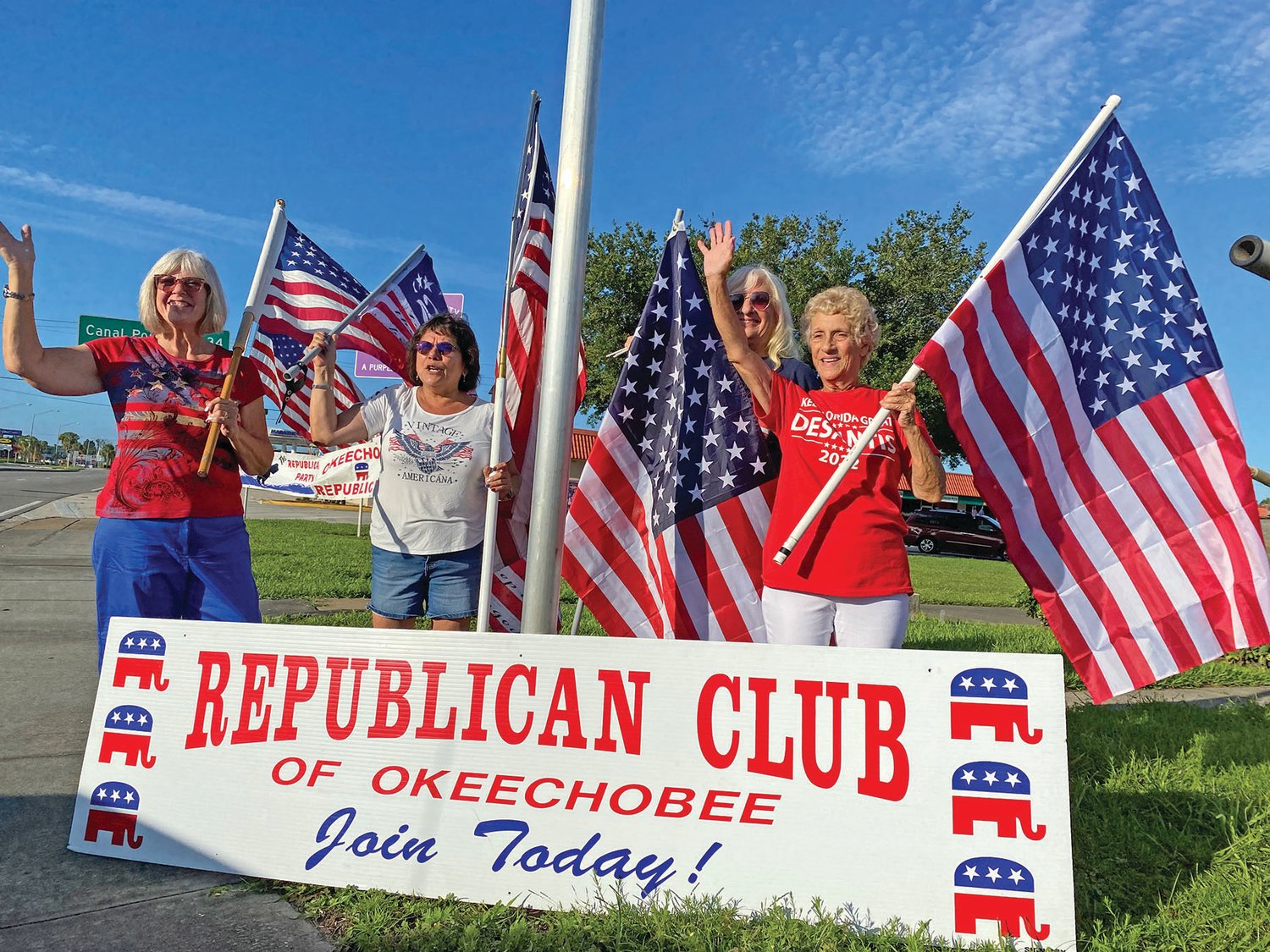 Left to right: Waving flags are Sallie Craig, Cynthia Holmes, Helen Brumit, and Club President Alicia LaChance.